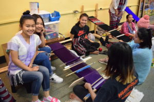 Youth demonstrate weaving at the Karen Student Weaving Showcase event in August